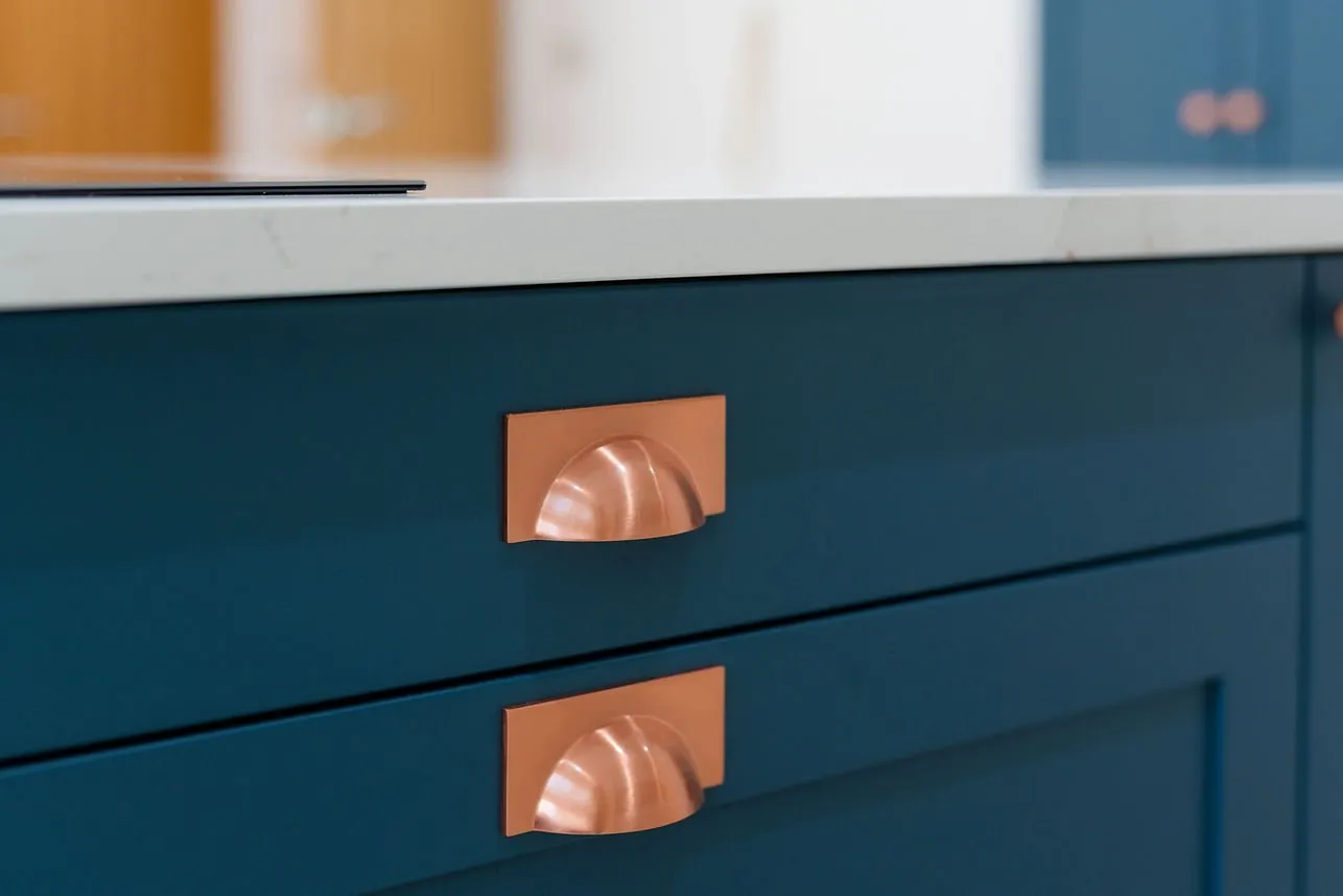 Copper cup handles on a painted shaker kitchen
