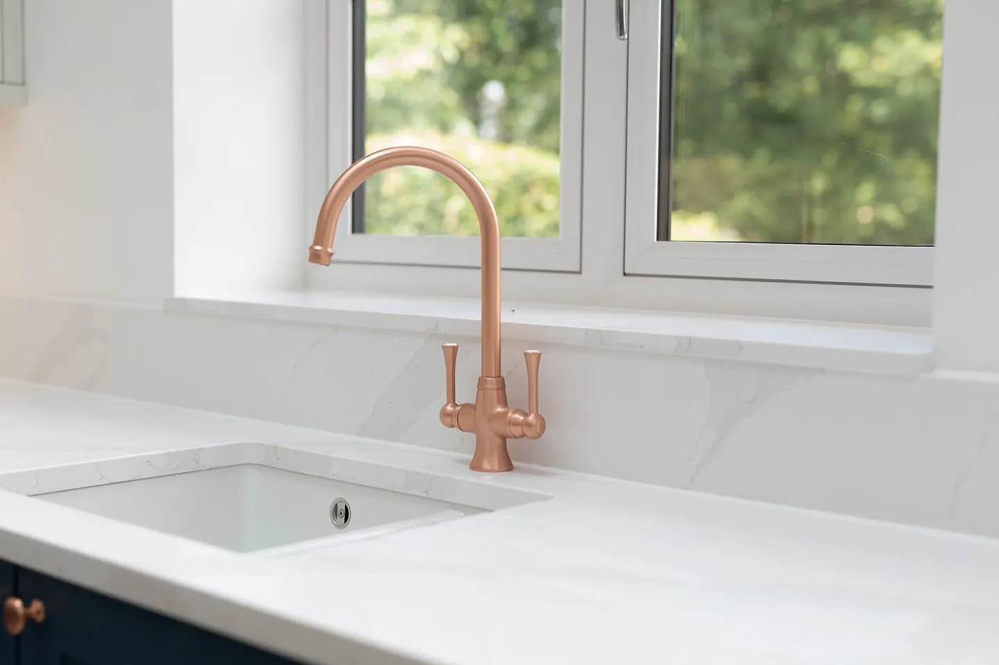 Copper tap on a quartz worktop