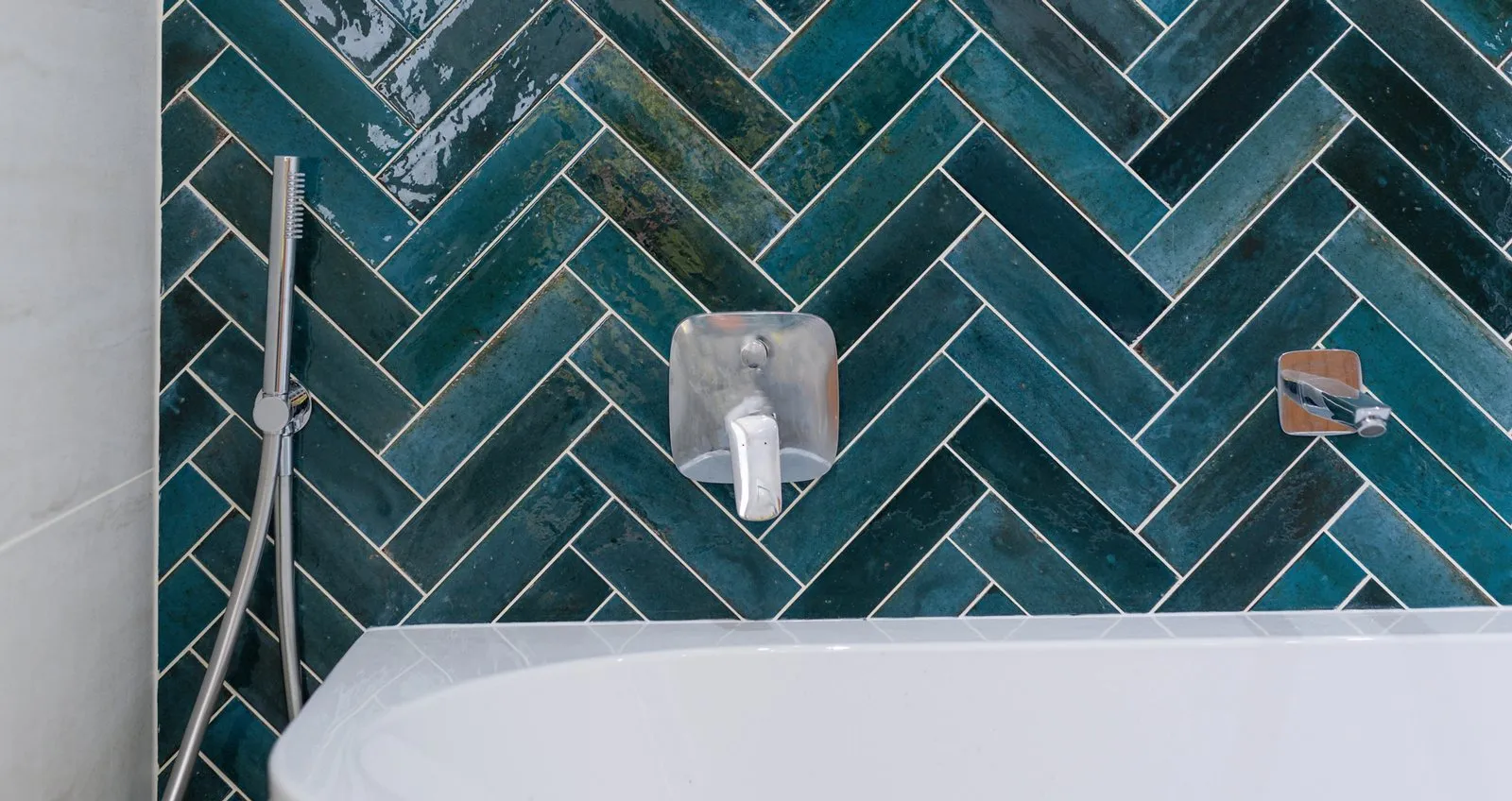 Herringbone tiles and a freestanding bath